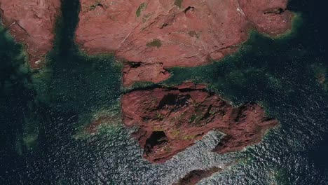 Bird's-eye-view-over-coastal-ocean-rocks-and-sea-water