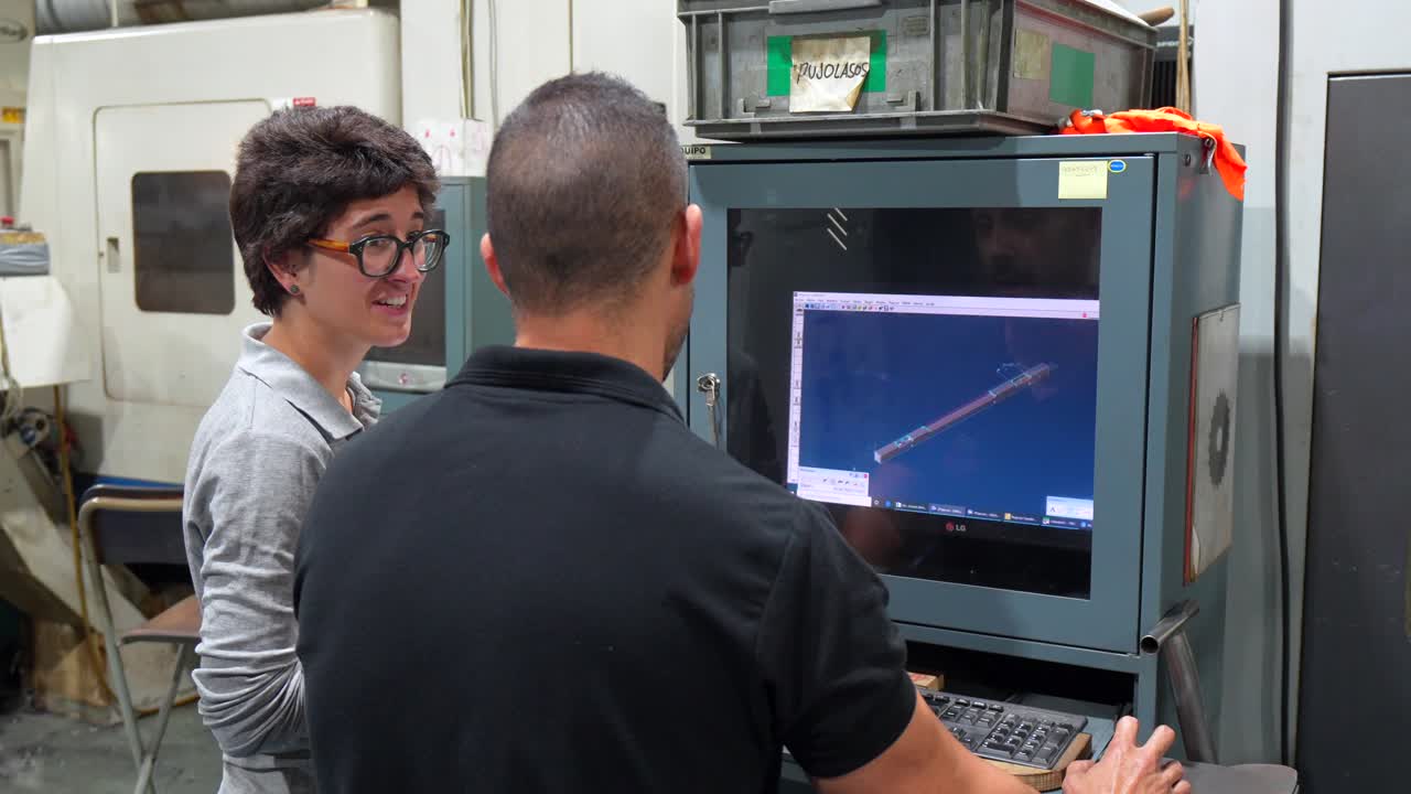 People working on a computer in a factory