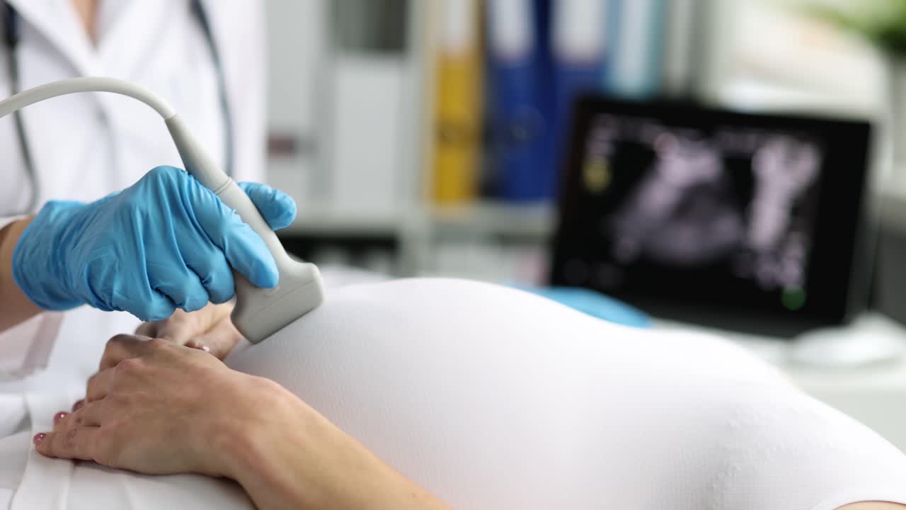 Pregnant woman undergoes ultrasound in clinic closeup