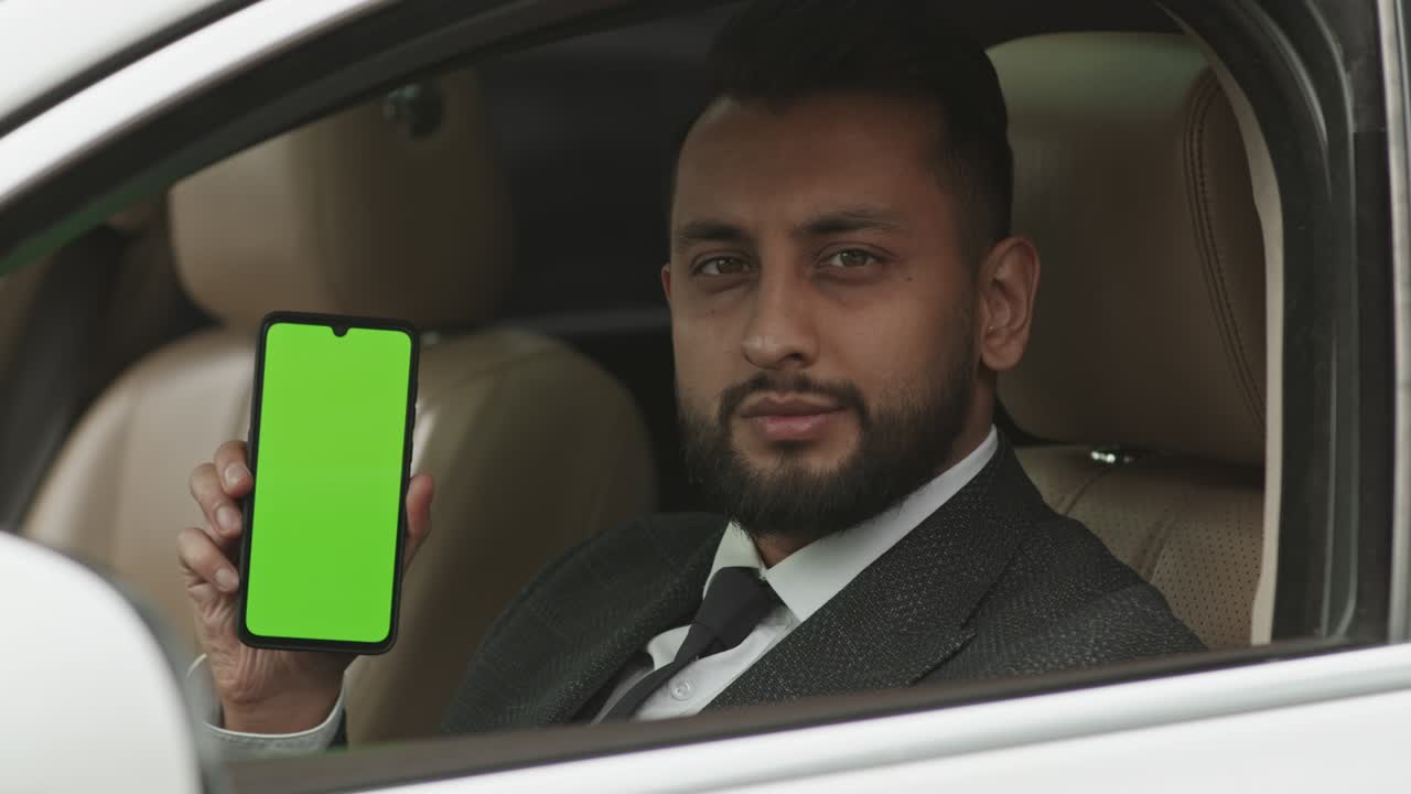 Professional Driver Posing with Green-screened Smartphone
