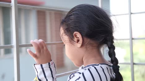 girl looking through a window