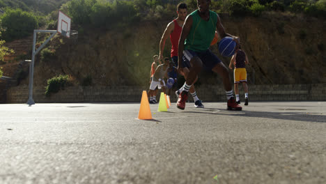 basketball players practicing dribbling drill