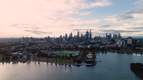 smooth aerial perspective approach over albert park lake toward melbourne cbd.