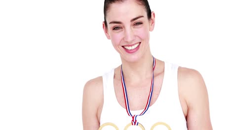 happy female athlete holding medal