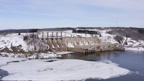 aerial: moving forward over trees toward mactaquac dam