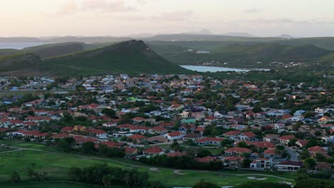 Sint-Michiel-and-Boka-Sami-homes-and-Christoffelberg-in-distance,-aerial-establishing