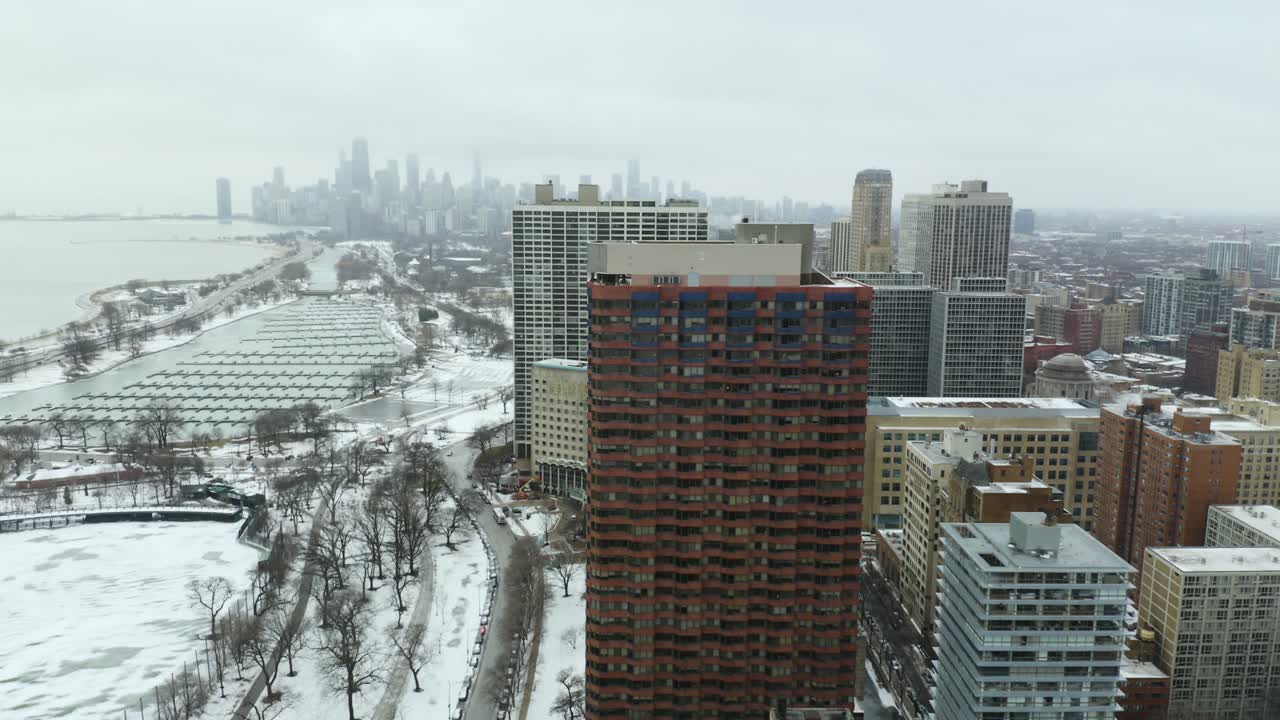 Aerial, Chicago Skyline Revealed during Orbit of Apartment Building on Cold Winter Day