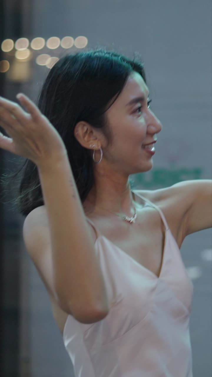 Woman smiling in city at night