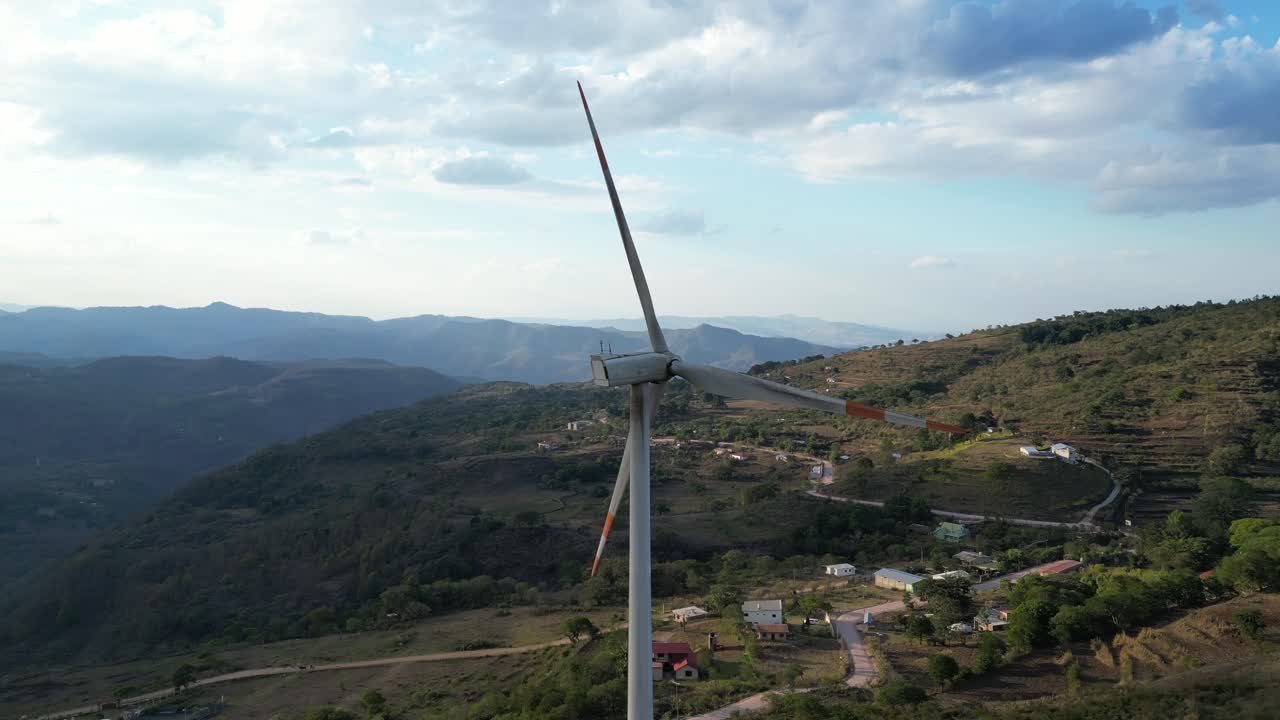 Windmill on Mountain Ridge Under Dramatic Sky, Renewable Energy for Greener Planet