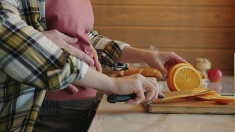 Couple preparing breakfast for a pregnant woman