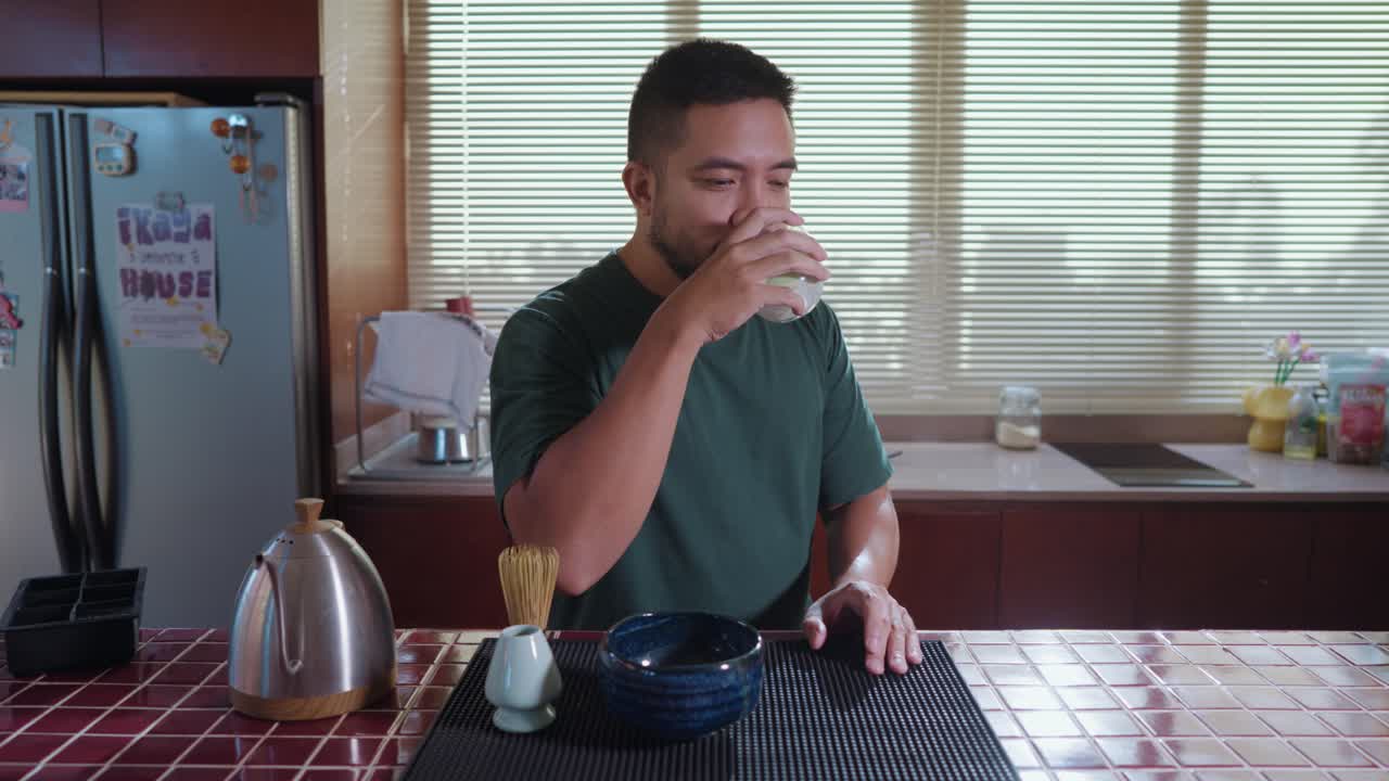 Man drinking tea in a kitchen