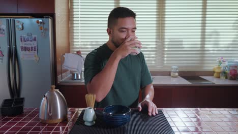 man drinking tea in a kitchen