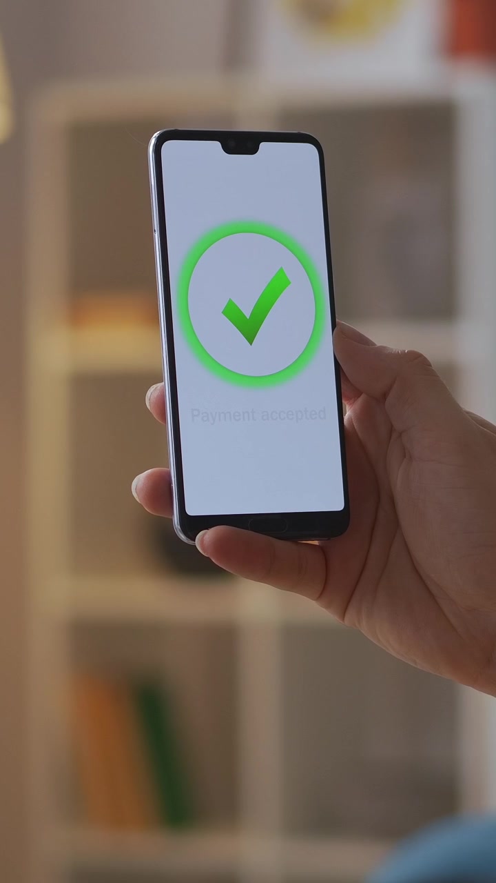 Mano che tiene uno smartphone con pagamento tramite portafoglio digitale accettato