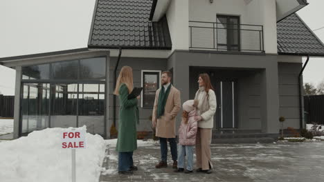 real estate agent showing house to family