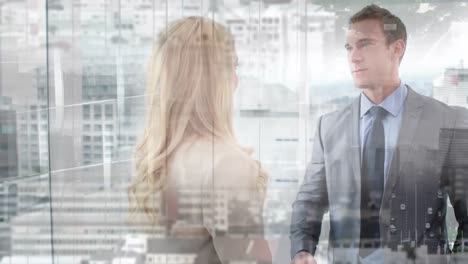 Caucasian-businessman-and-businesswoman-shaking-hands-at-office-against-aerial-view-of-cityscape