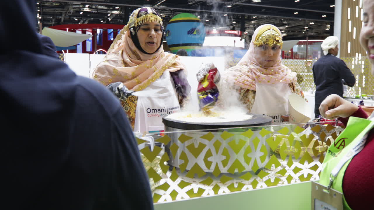 Oman women cooking traditional foods in a travel show World Travel Market in London.