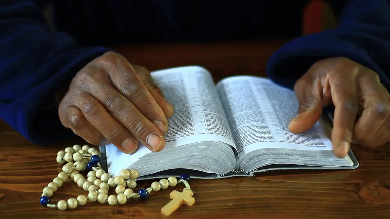 praying to God with hand's together on bible with people and white background stock video stock footage