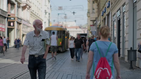 city street scene with people and tram