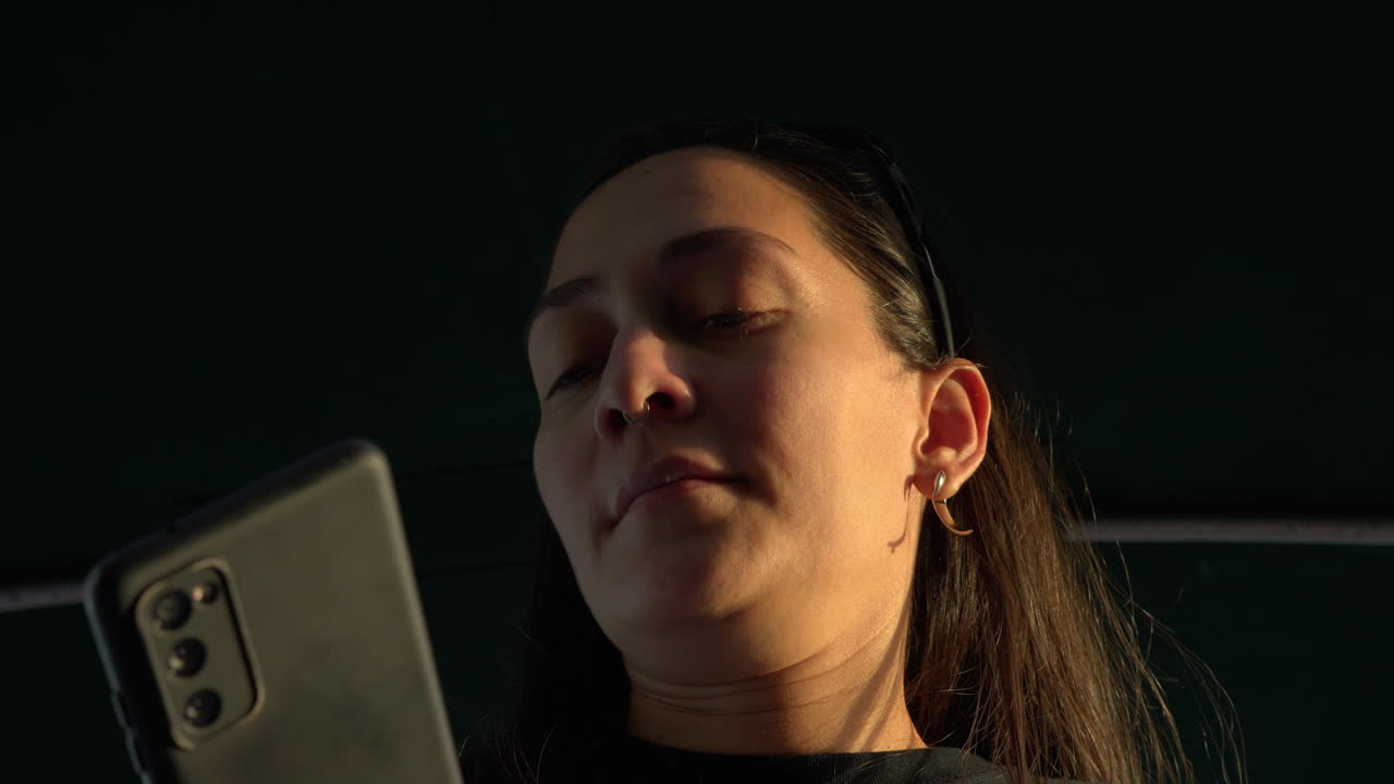 Low-angle shot of a young woman taking photos of the scenery in Panama