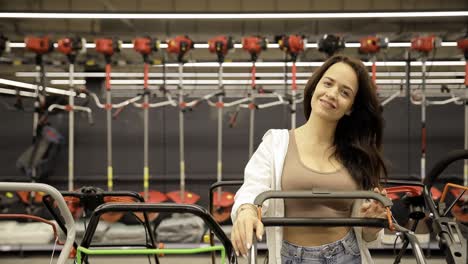 a garden tool store consultant shows a lawnmower. tools for gardening.