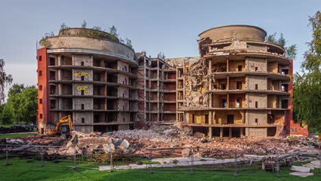 demolition timelapse of a building being torn down with hydraulic excavators