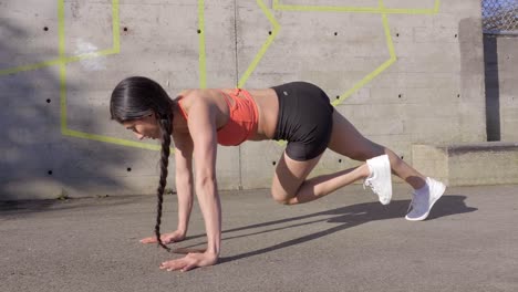 Fit-young-woman-doing-mountain-climbers-abdominal-exercise-outdoor