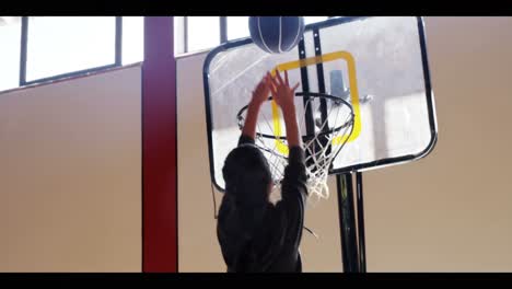 high school kid scoring a dunk