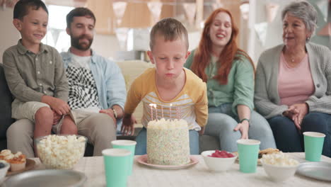 Blowing,-birthday-boy-or-big-family-with-cake