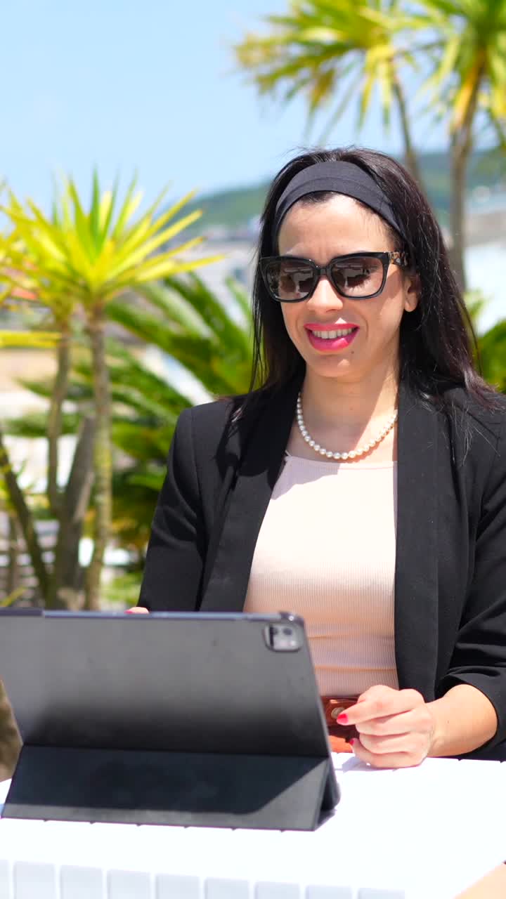 Businesswoman working on tablet outdoors