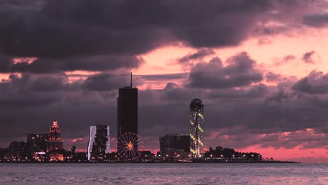 batumi, adjara, georgia. modern architecture in seafront promenade in night or evening illuminations lights, illuminated resort town cityscape with skyscrapers
