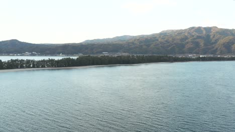 Aerial-pan-along-the-sea-at-Amanohashidate,-Kyoto-Japan