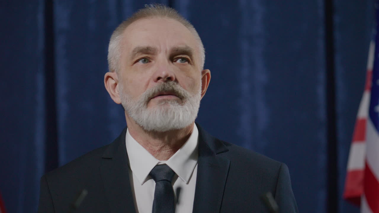 Senior Politician Addressing Media at Press Conference