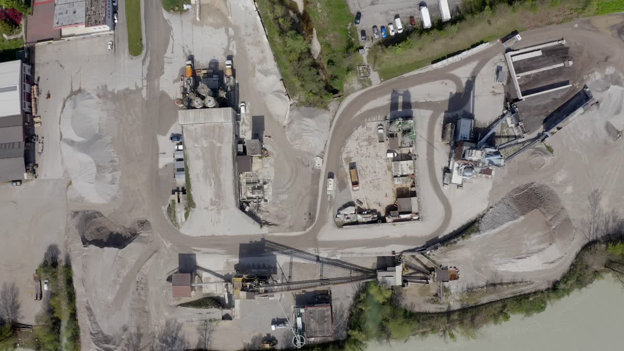 Slow downward spiraling aerial movement to the local quarry site for construction industry.