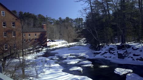 royal river in winter flowing by old mill in yarmouth, maine