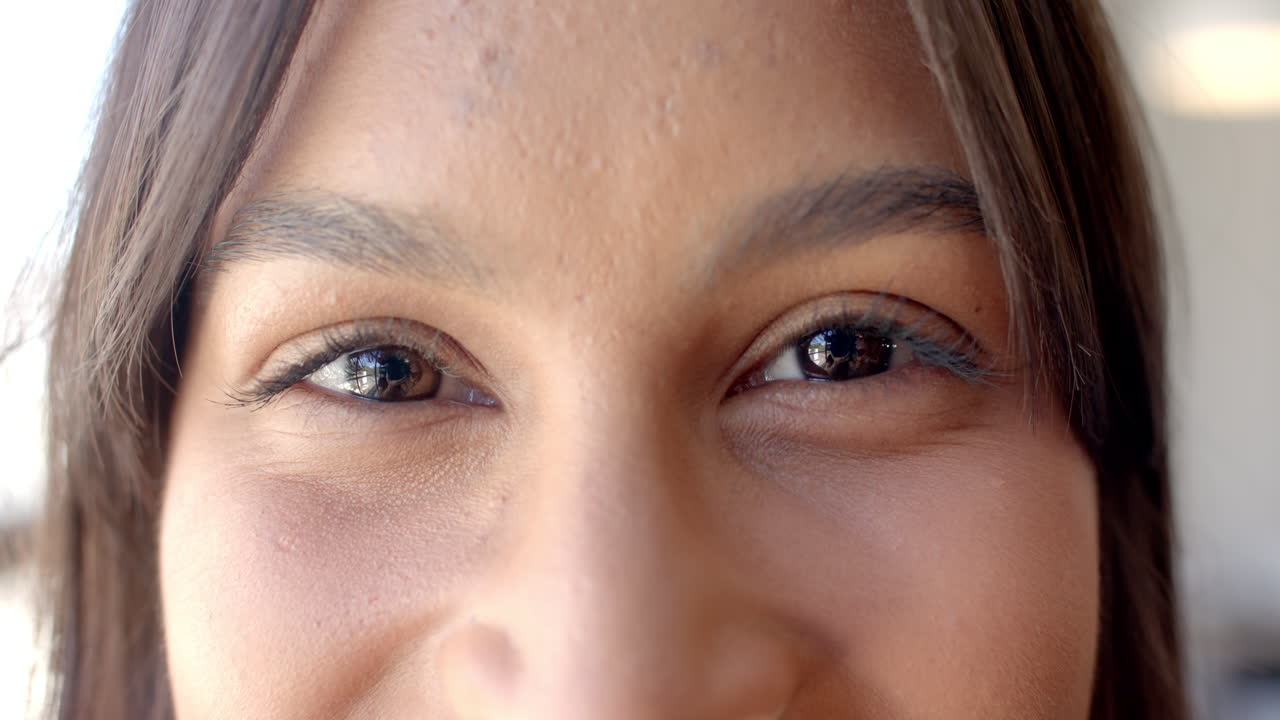 Close-up of woman eyes, smiling and expressing confidence in business setting