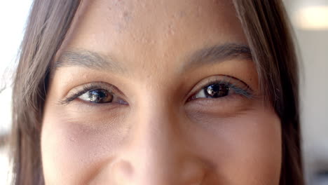 close-up of woman eyes, smiling and expressing confidence in business setting