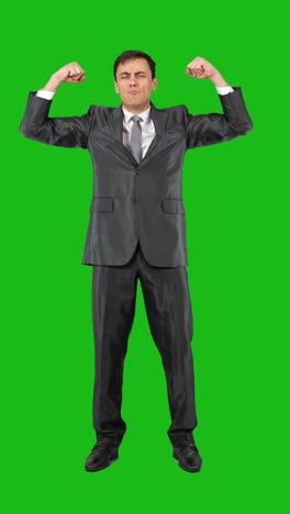 businessman flexing and celebrating on green screen