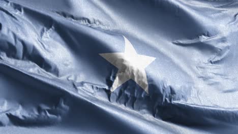 bandera textil de somalia ondeando en el bucle del viento. estandarte somalí balanceándose en la brisa. tejido textil de tela. fondo de relleno completo. bucle de 10 segundos.