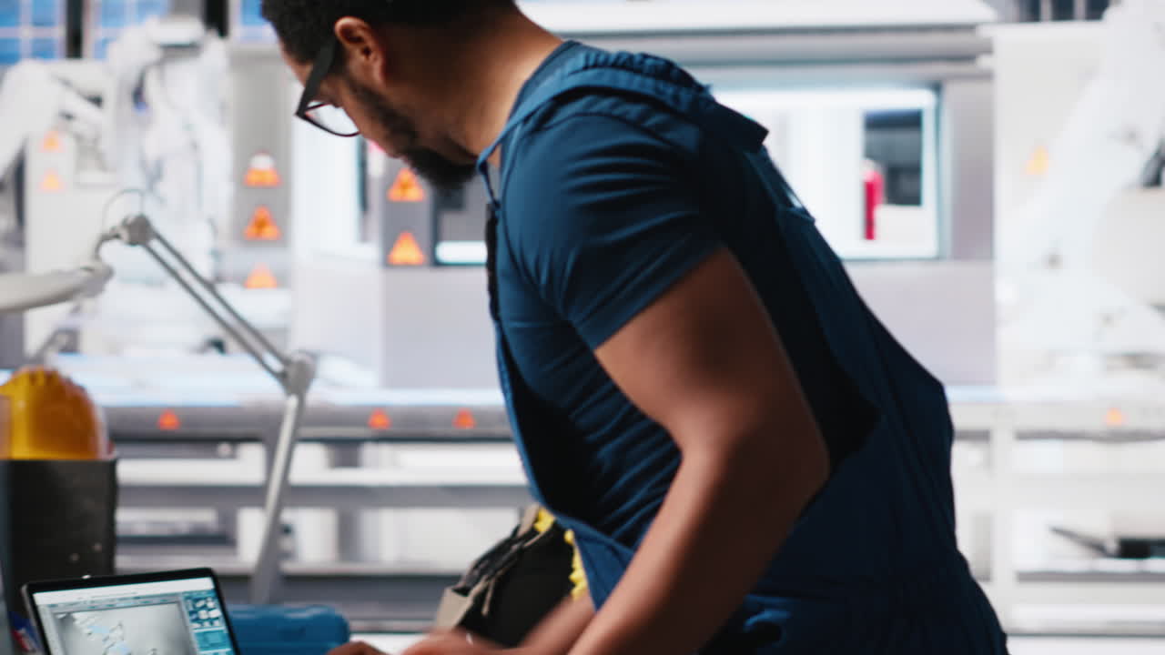 Black engineer inputs solar system parameters at industrial workstation