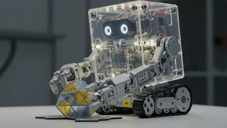 a cutting-edge robotic manipulator engaged in object handling with a transparent design, showcasing advanced technology and precision in robotics innovation