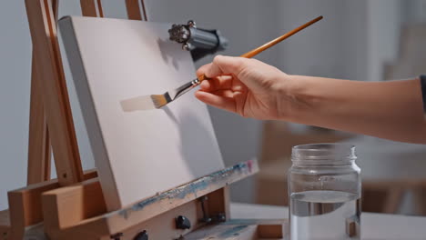 a hand painting on a blank canvas