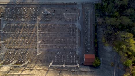 Top-down-aerial-view-of-electricity-substation,-hydropower,-industry,-dam