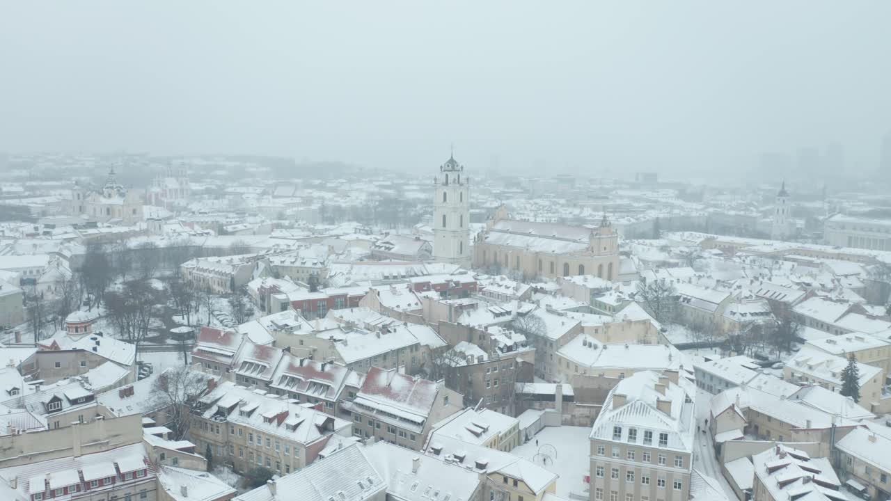 Aerial footage showcases Vilnius' quiet neighborhoods, their rooftops and gardens hidden beneath a thick layer of fresh snow