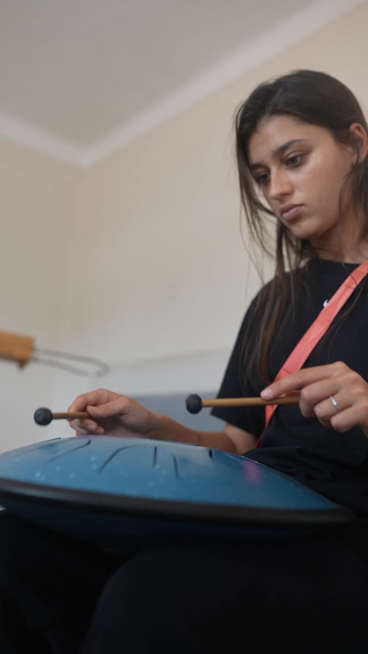 Woman playing a hand pan