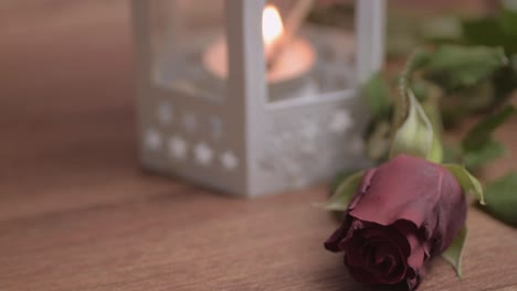 Lighting-a-candle-with-red-rose-for-romantic-evening