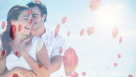 happy couple cuddling on a sunny day with red balloon for valentine day