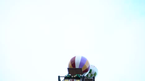 outdoor mini balloon colorful ferris wheel at tivoli gardens amusement park, copenhagen, denmark, close up slow motion