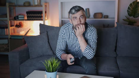 man watching tv at night