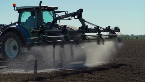 tractor spraying liquid on a field