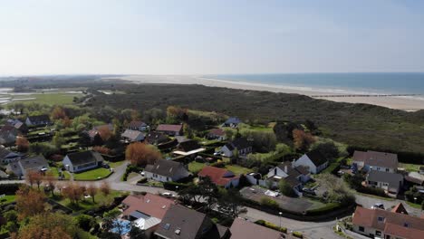 Drone-shot-flying-over-houses-along-the-Dunkirk-coastline-in-Northern-France